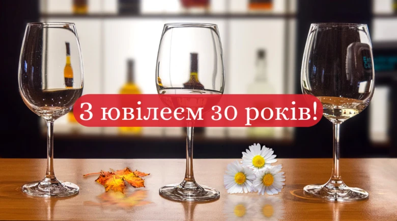 Три склянки з вином та квіти на столі до ювілейного привітання.