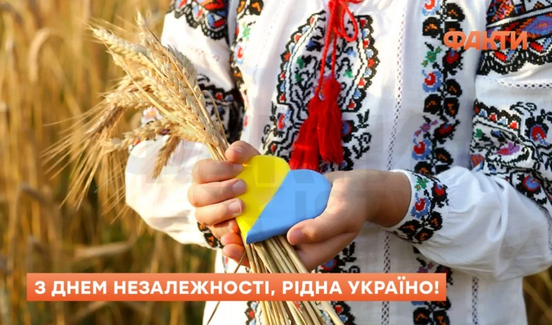 Людина в вишиванці тримає колосся пшениці у формі прапора України.
